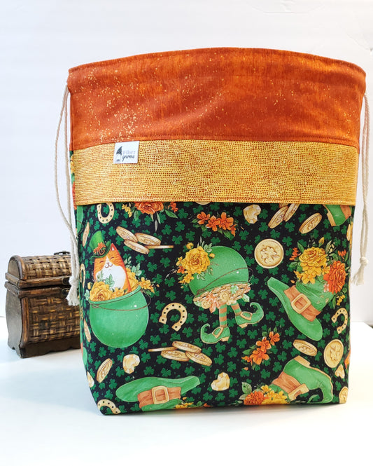 Drawstring bag with green leprechaun (as cats) design on a white background